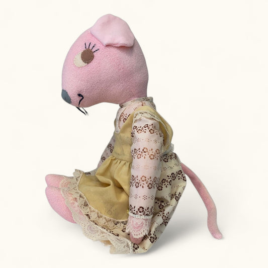 Stuffed mouse toy with a floral dress on a white background