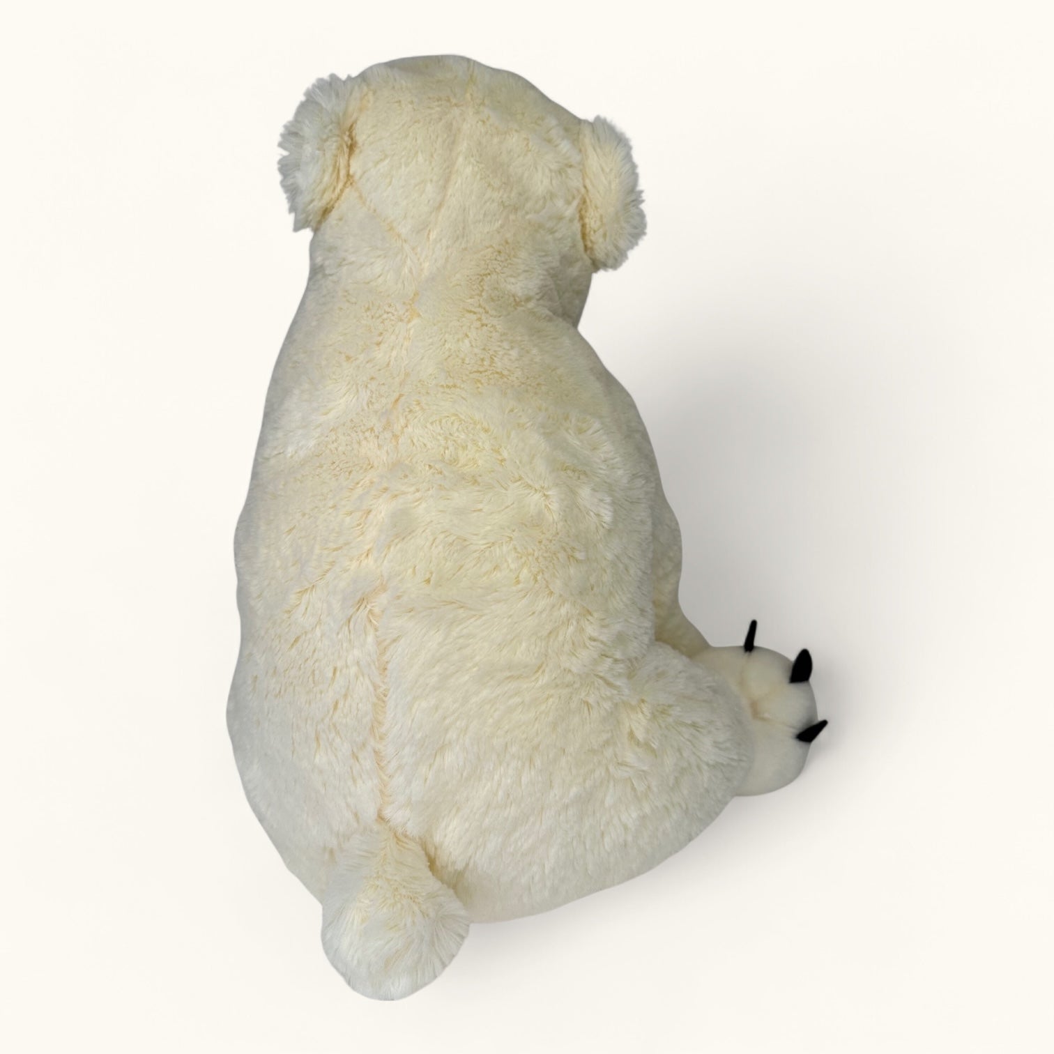 White plush polar bear toy on a white background