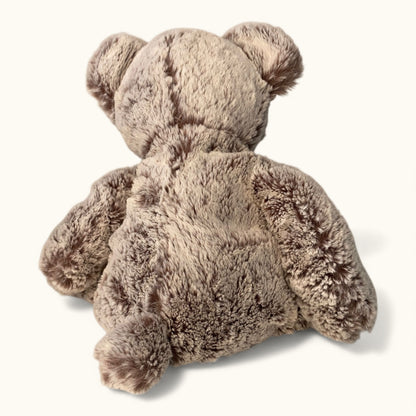 Back view of a fluffy teddy bear on a white background