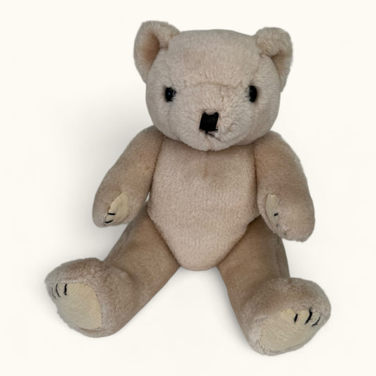 Beige teddy bear on a white background