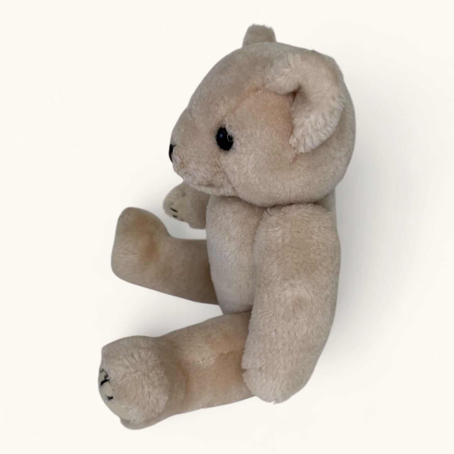 Beige stuffed animal toy on a white background