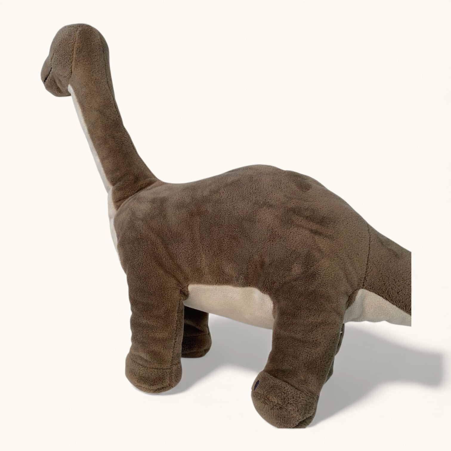 Plush dinosaur toy on a white background