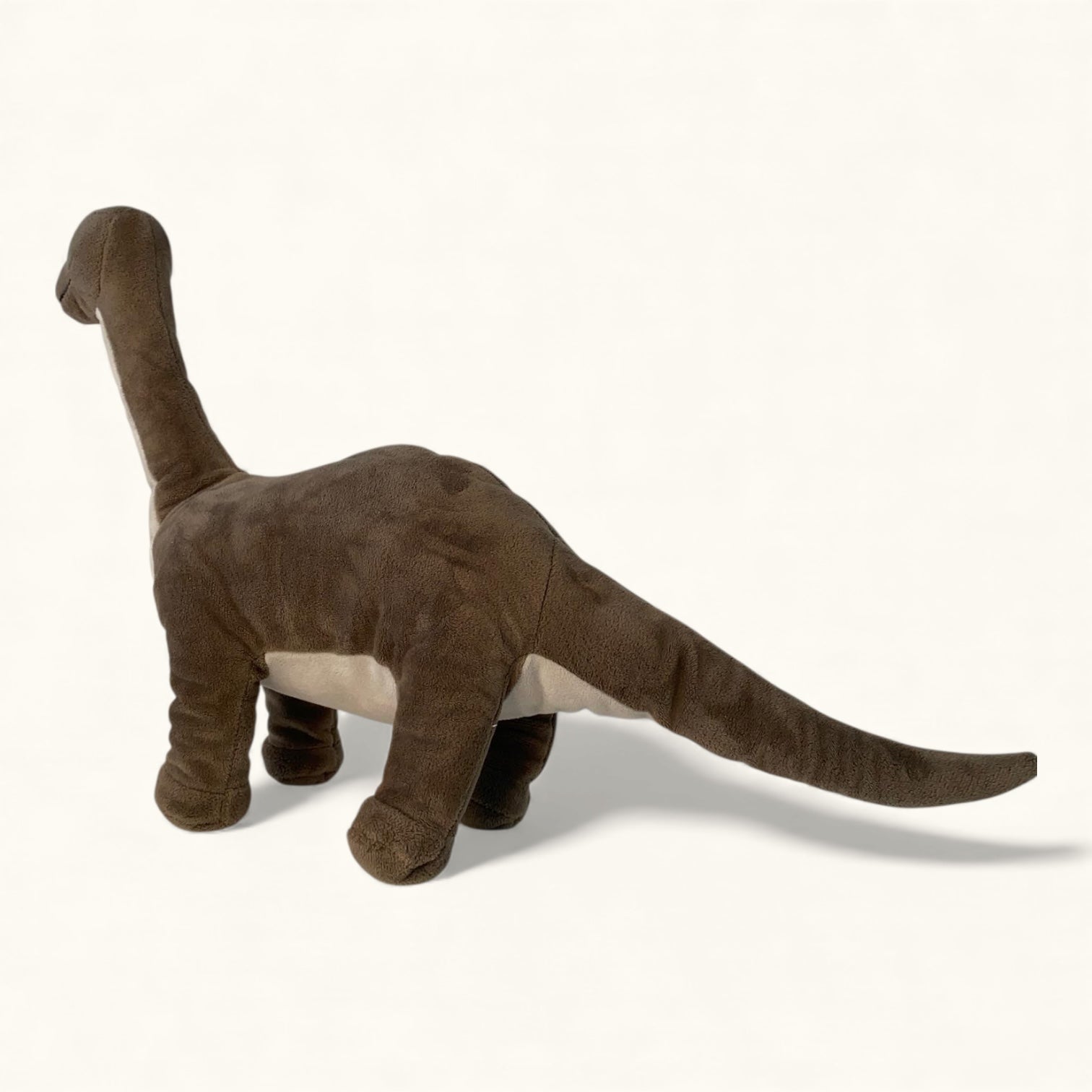 Plush dinosaur toy on a white background