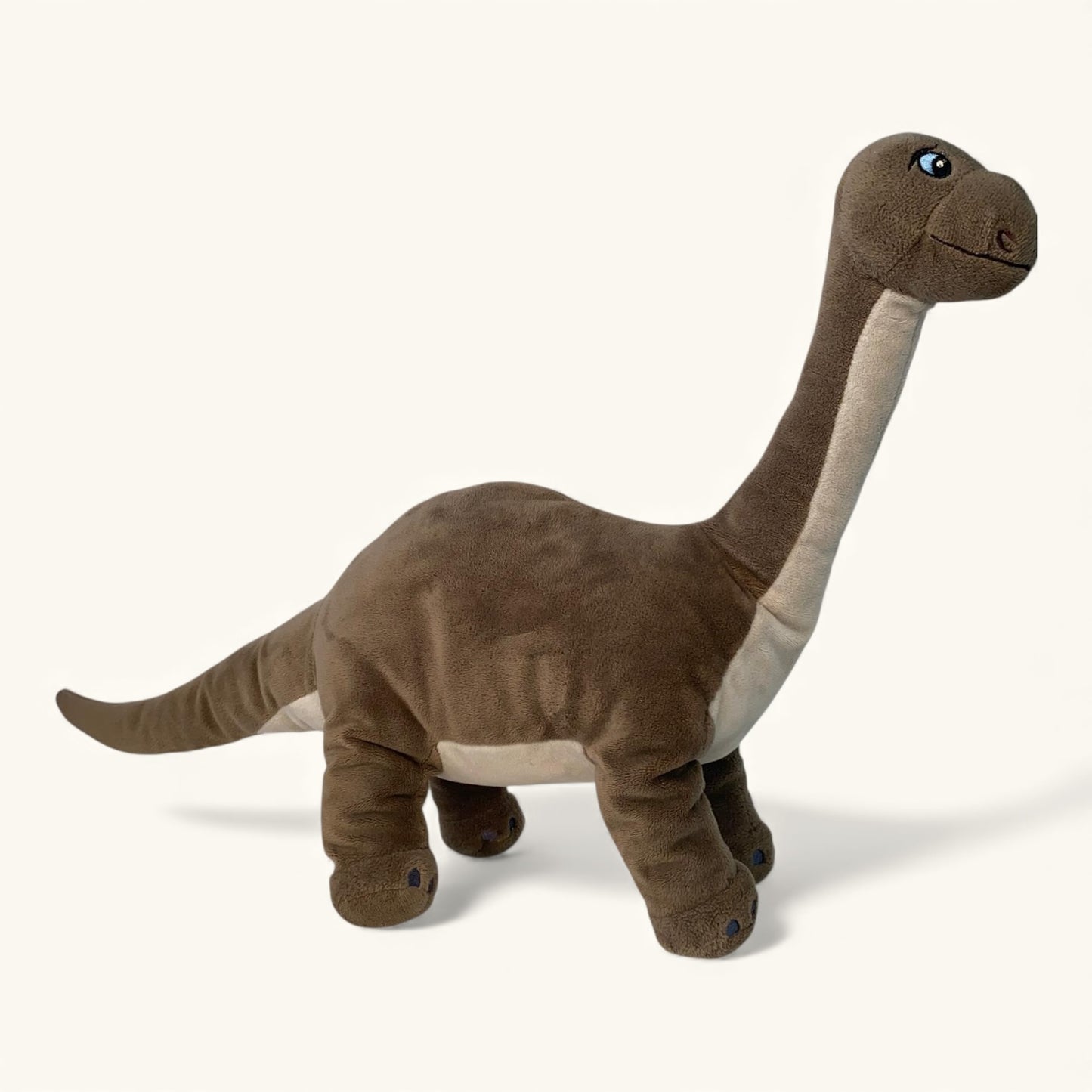 Plush dinosaur toy on a white background