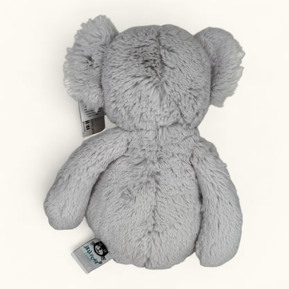 Gray plush toy with a tag on a white background
