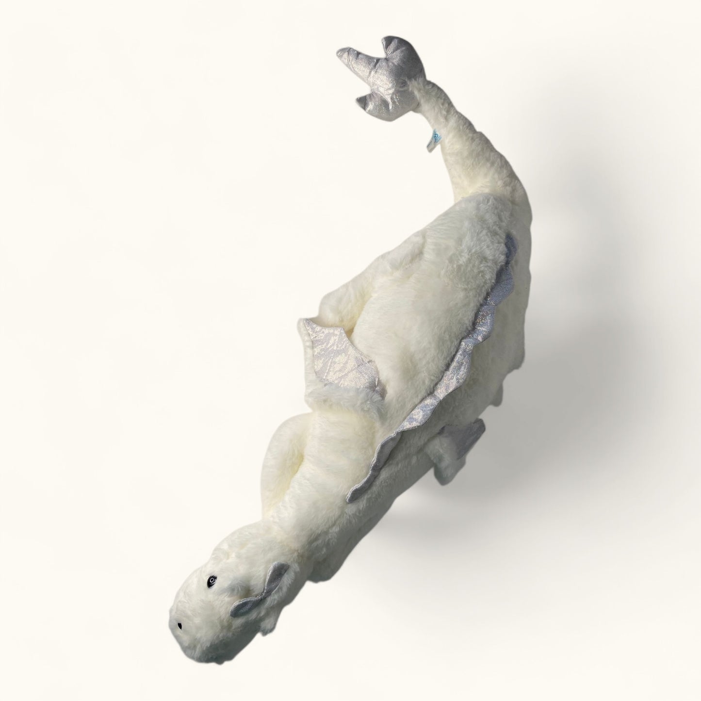 Plush dragon toy on a white background