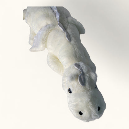 White plush toy resembling a dragon on a white background
