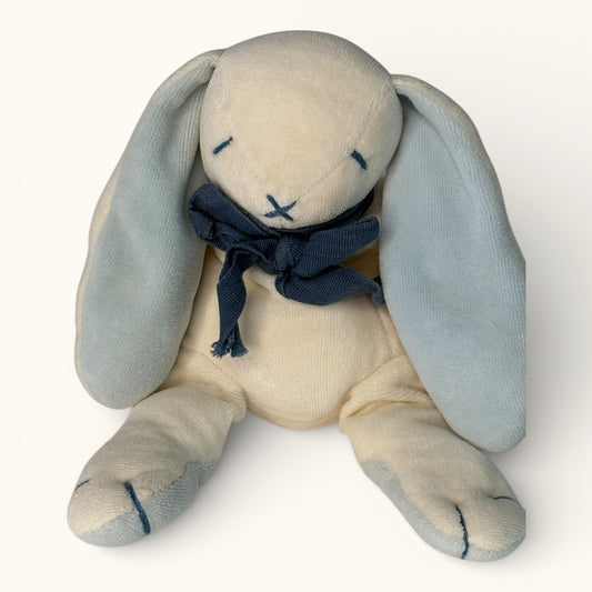 Stuffed bunny toy with a navy blue scarf on a white background