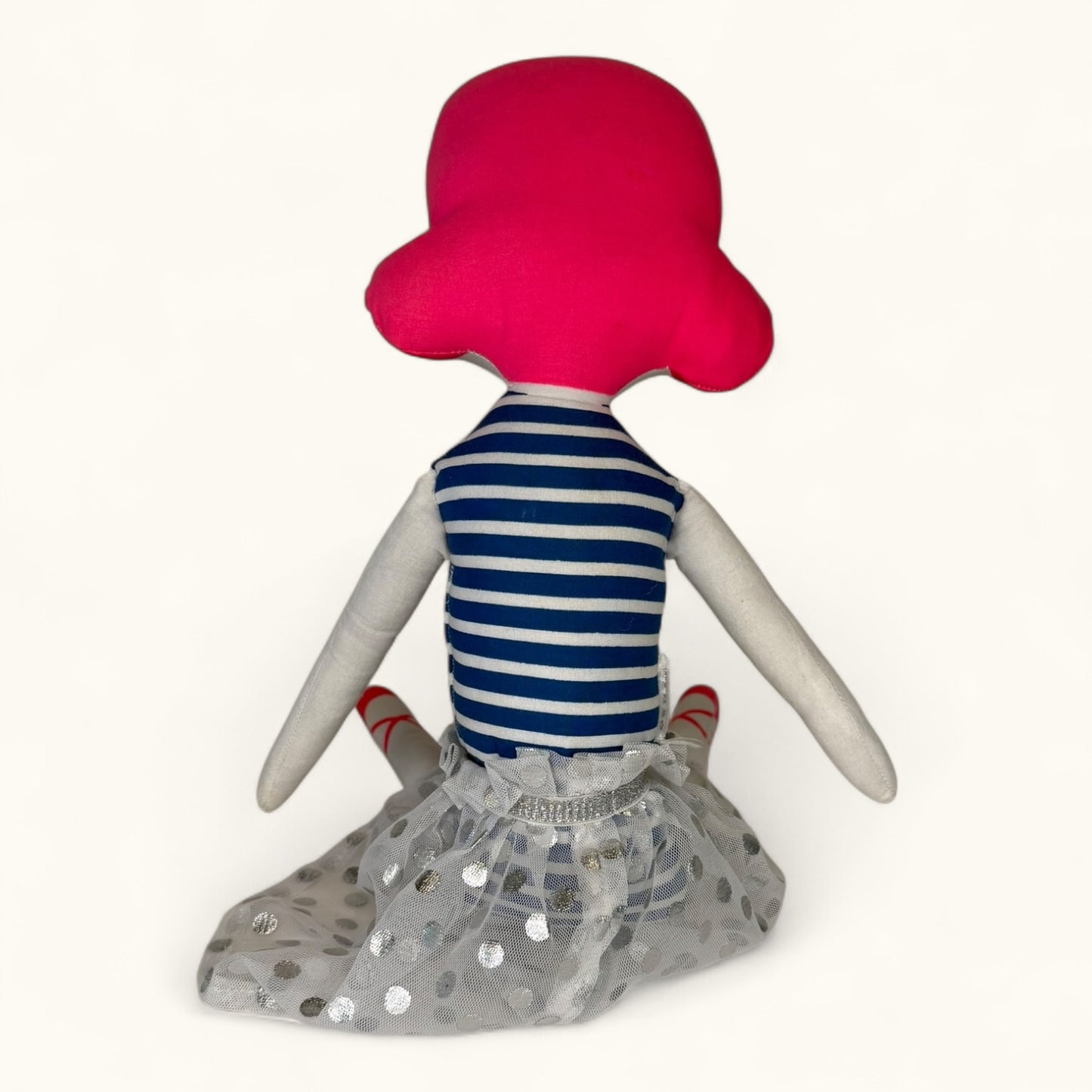 Plush toy with a red head, striped shirt, and gray skirt on a white background
