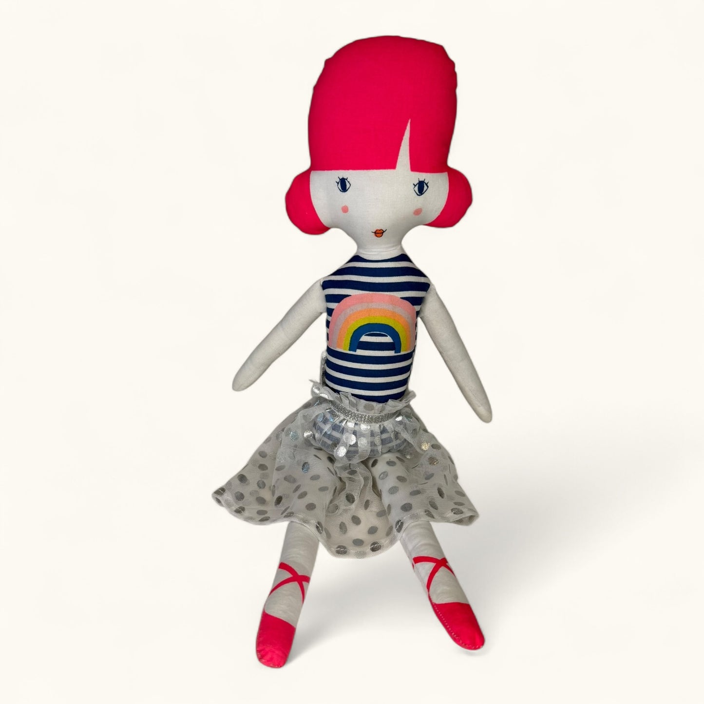 Stuffed doll with red hair, striped shirt, and polka dot skirt on a white background