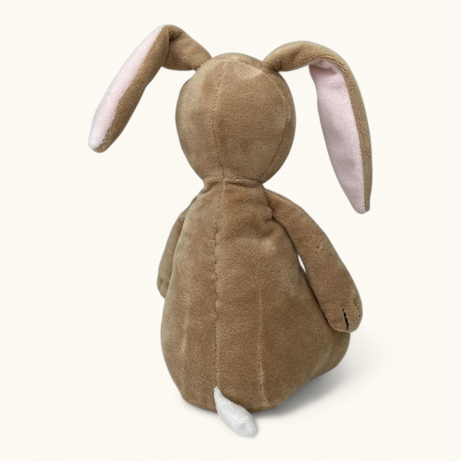 Brown plush bunny toy with white paws on a white background