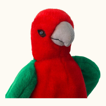 Red and green plush parrot toy on a white background