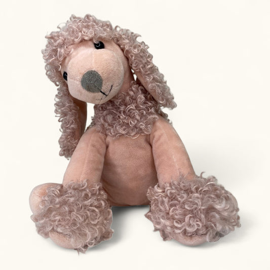 Plush toy dog with curly fur on a white background