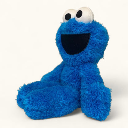 Blue plush toy with a smiling face on a white background