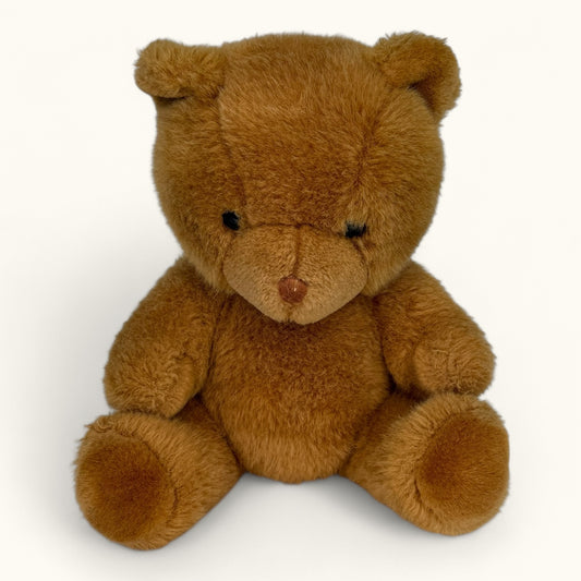 Brown teddy bear on a white background