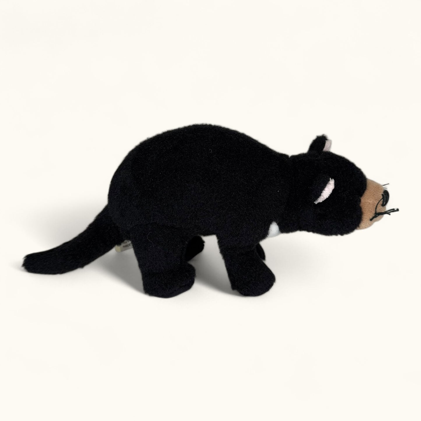 Black plush toy Tasmanian devil on a white background