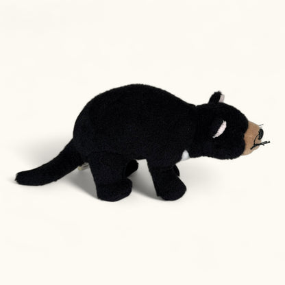 Black plush toy Tasmanian devil on a white background