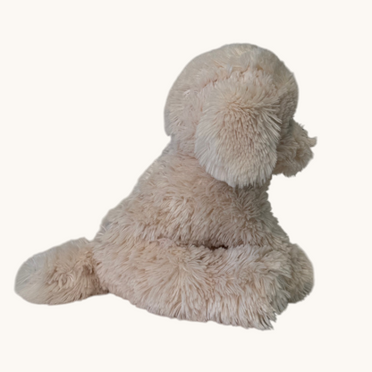A plush dog toy with fluffy, shaggy light beige fur, shown from the back against a plain off-white background.