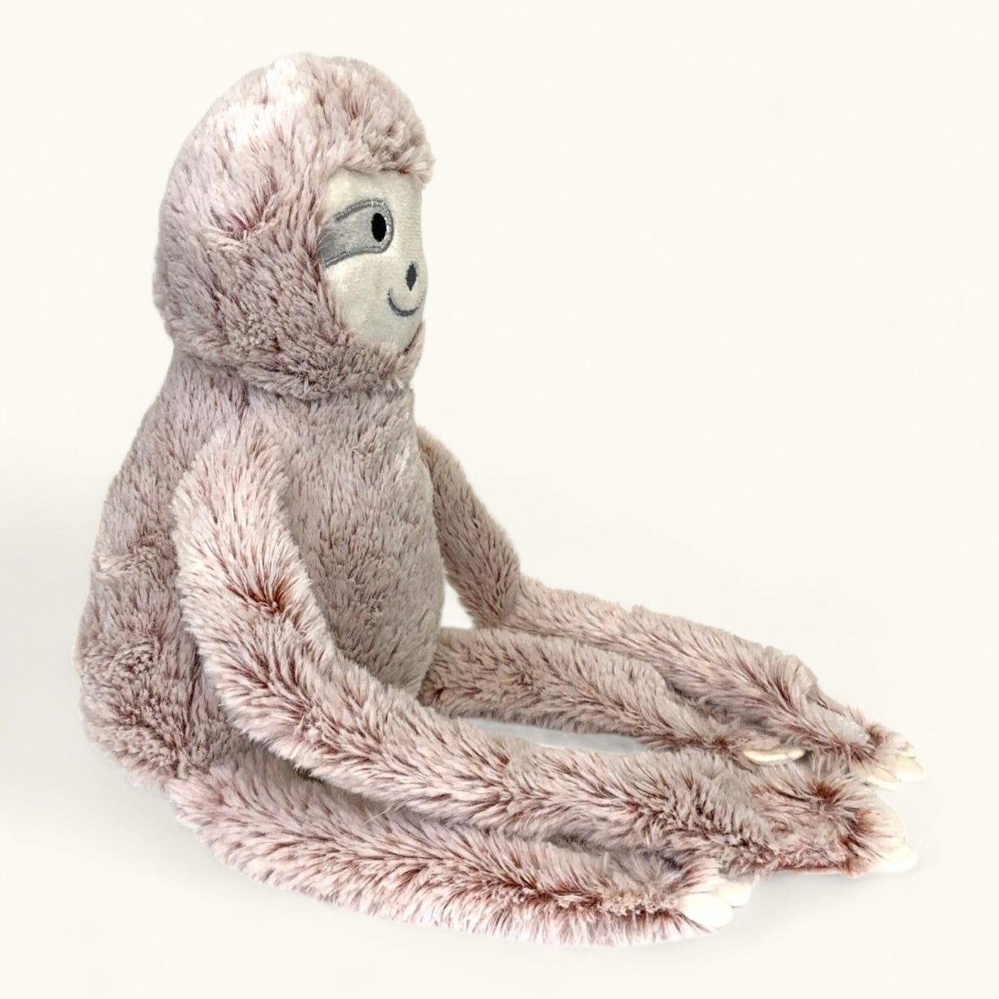 Plush toy sloth on a white background