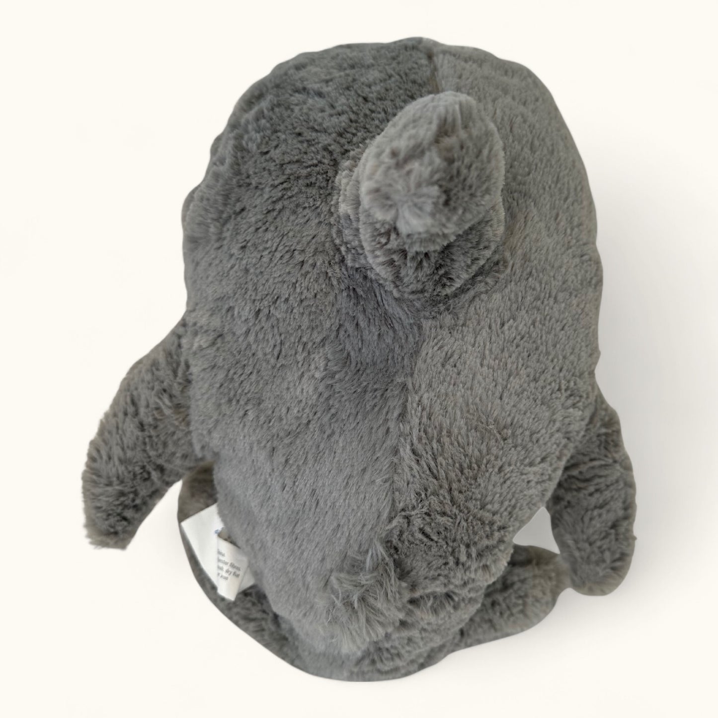 Gray plush toy on a white background