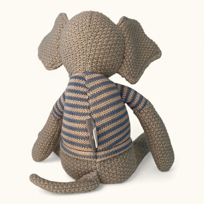Knitted elephant toy wearing a striped sweater on a white background