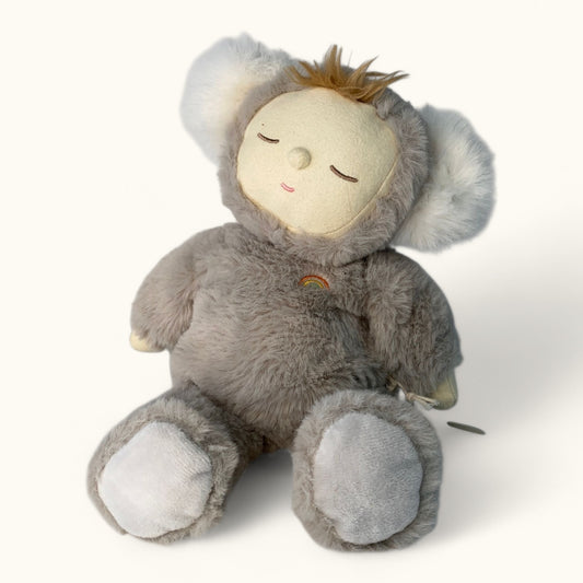 Plush toy koala with a small figure on a white background