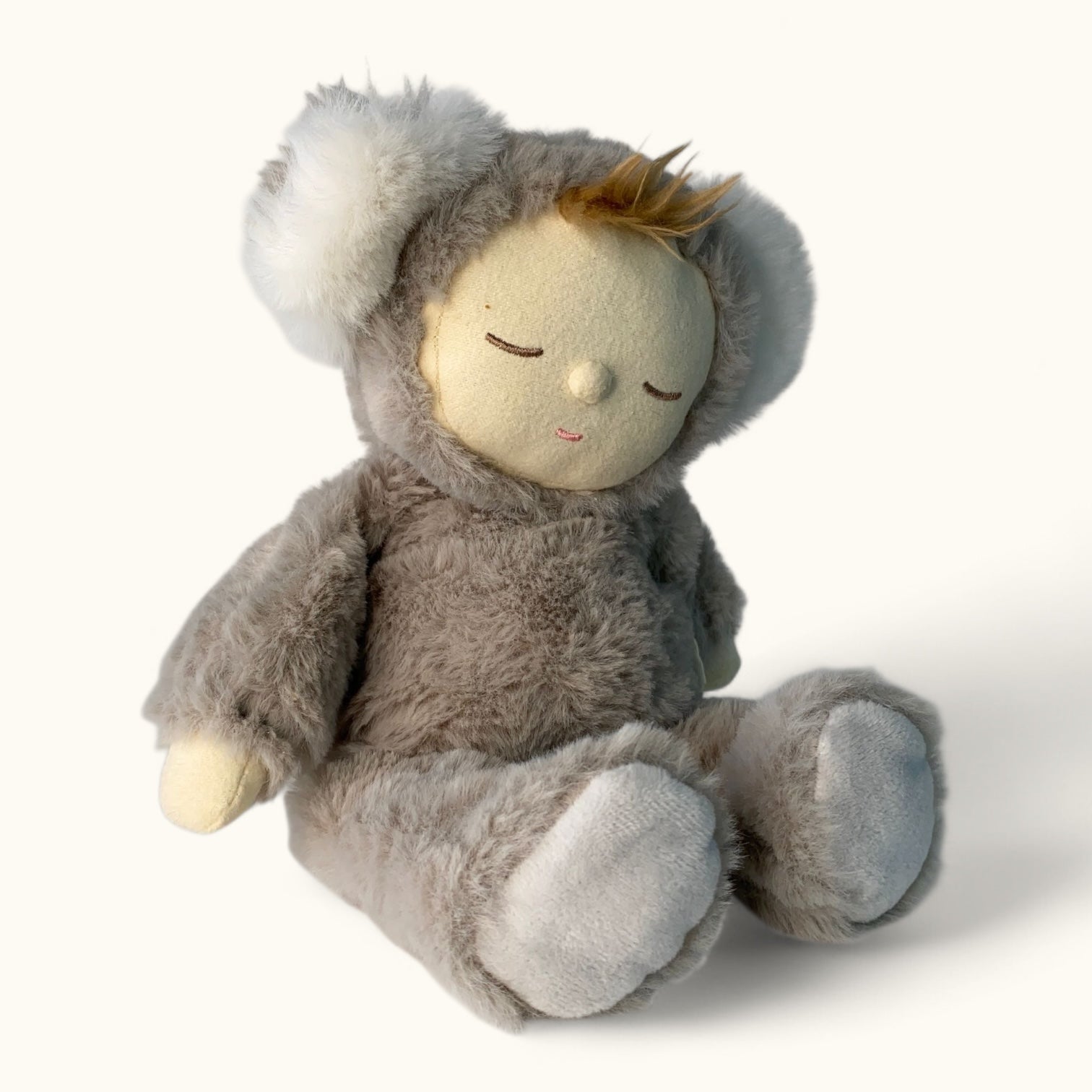Plush toy resembling a child in a koala bear costume on a white background