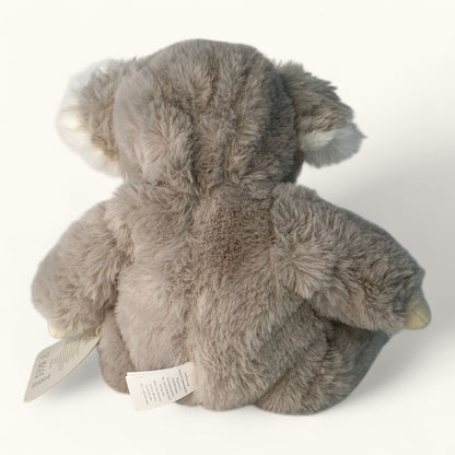 Gray plush koala bear toy with a tag on a white background
