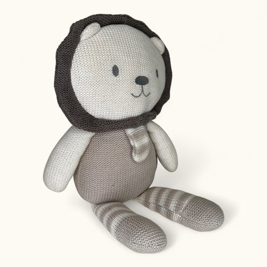 Knitted toy bear with a lion head on a white background