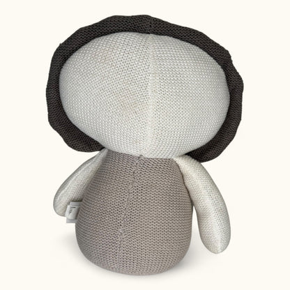 Knitted doll with a black hat on a white background
