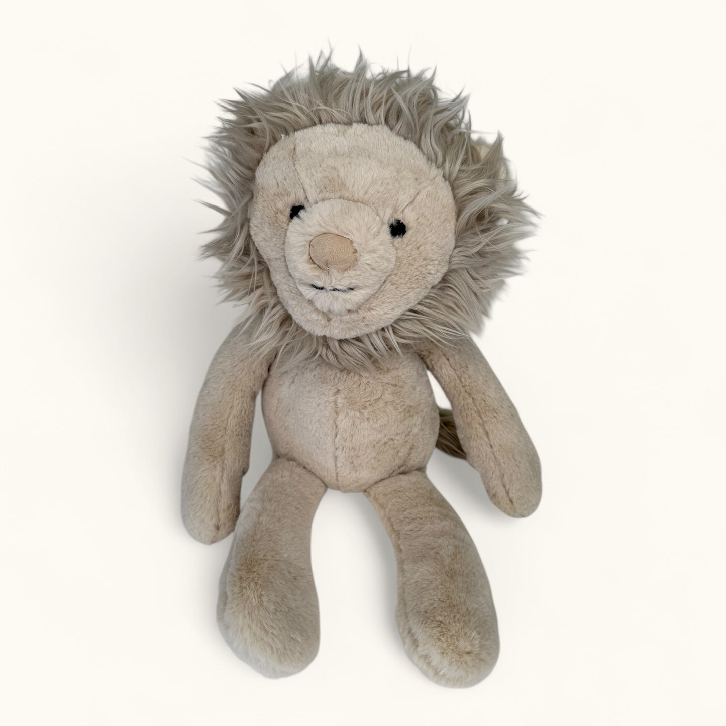 Plush lion toy on a white background