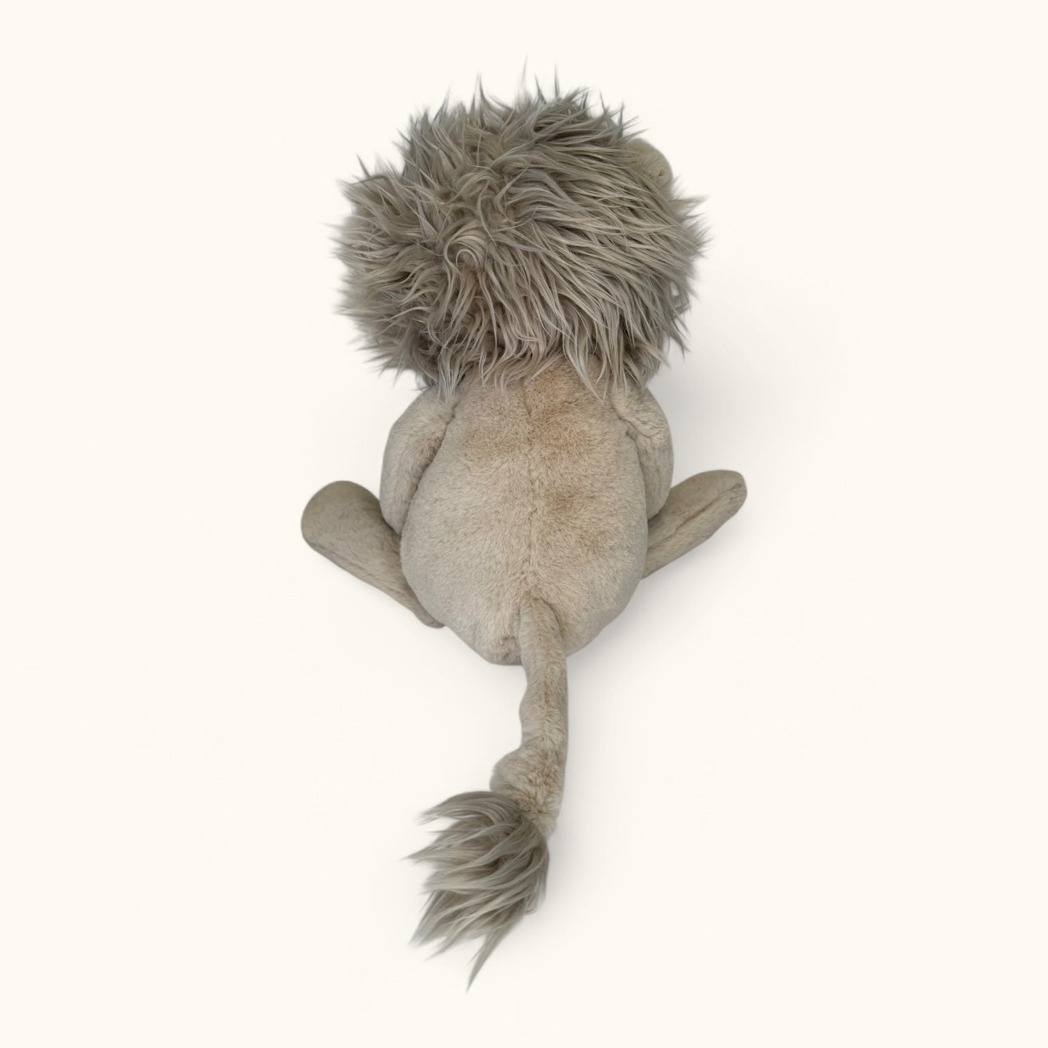 Plush lion toy from behind on a white background