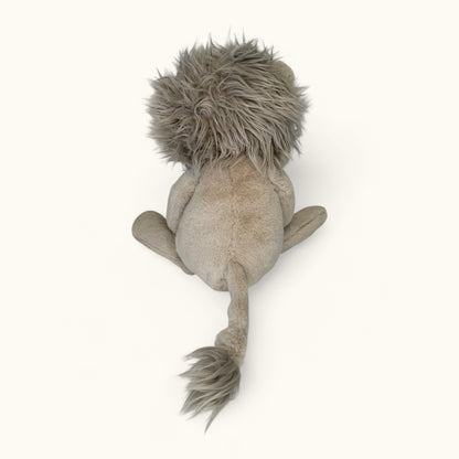 Plush lion toy from behind on a white background