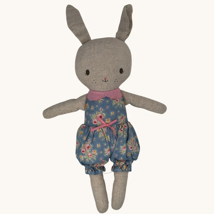 Stuffed toy rabbit wearing a floral outfit on a white background