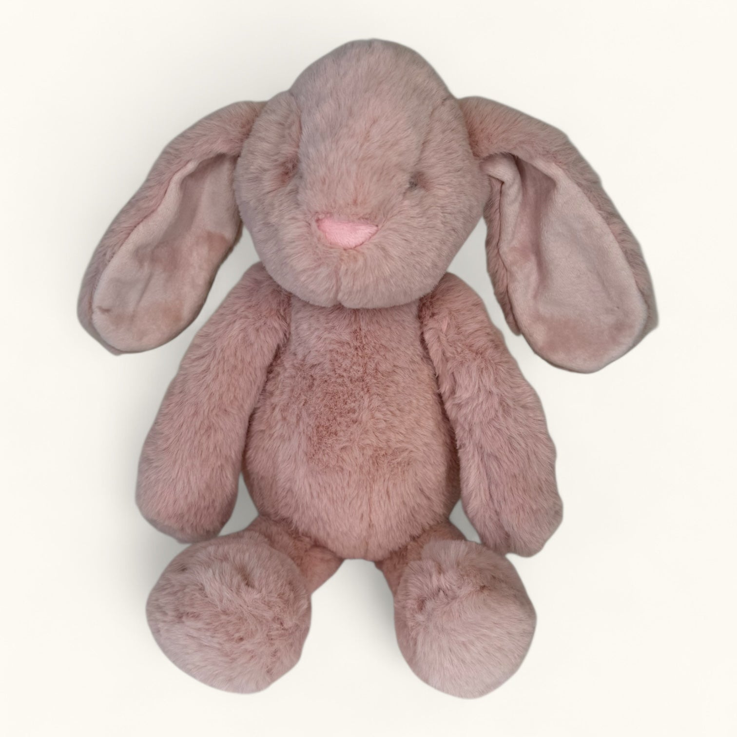 Pink plush bunny toy on a white background