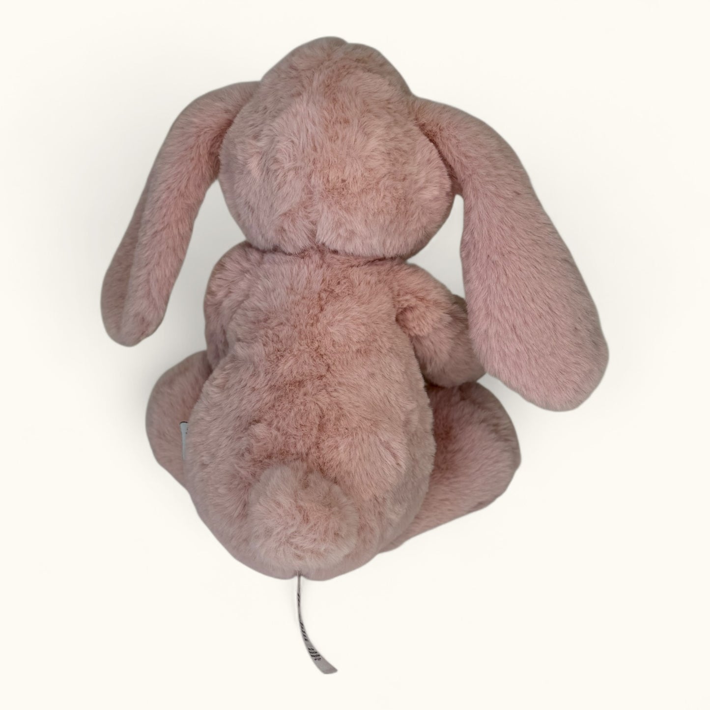 Pink plush bunny toy on a white background