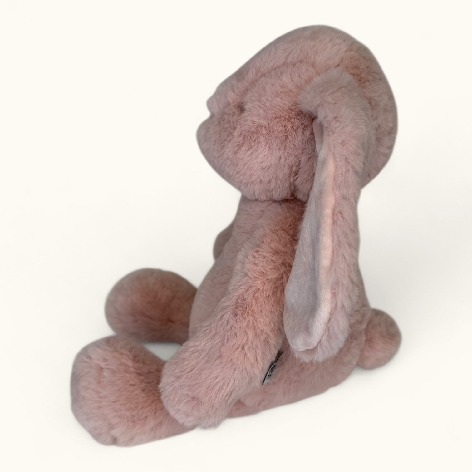 Pink plush bunny toy on a white background
