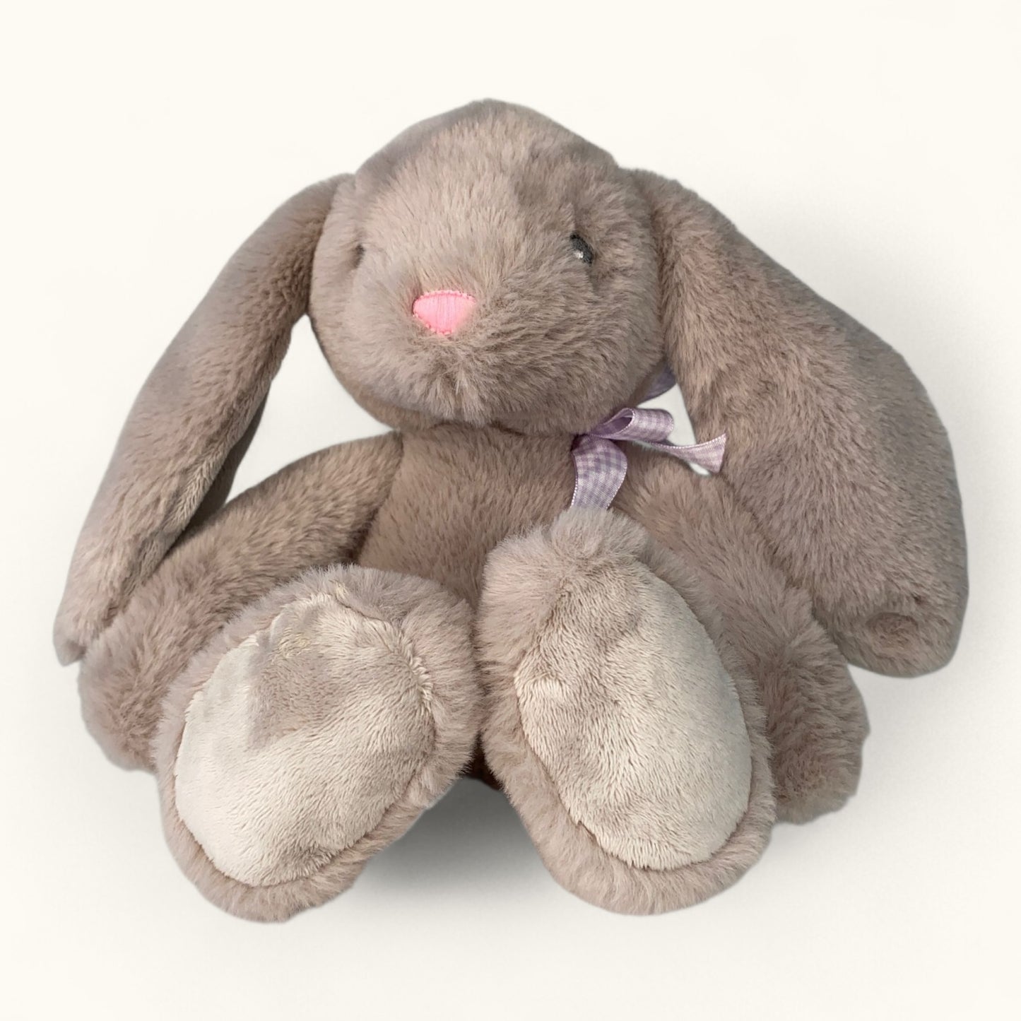 Plush toy rabbit with a pink bow on a white background