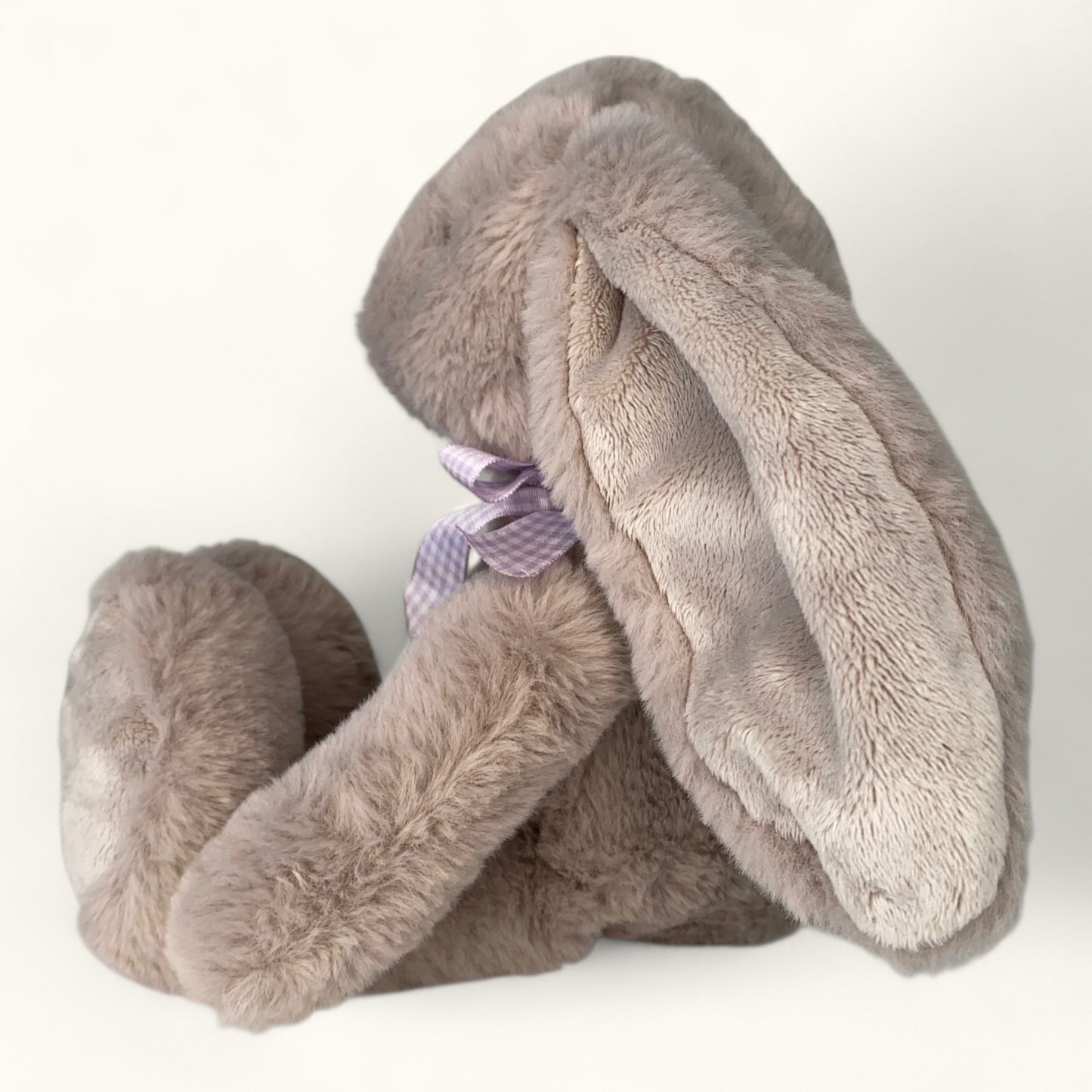 Plush bunny toy with a bow tie on a white background