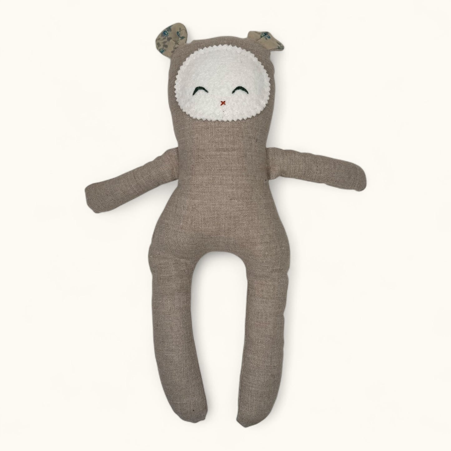 Brown plush toy with a white face on a white background