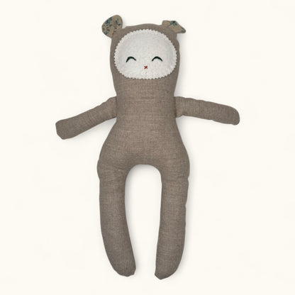 Brown plush toy with a white face on a white background
