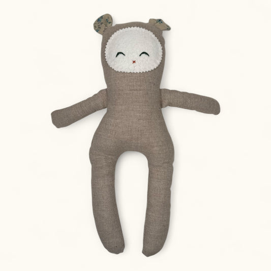 Brown plush toy with a white face on a white background