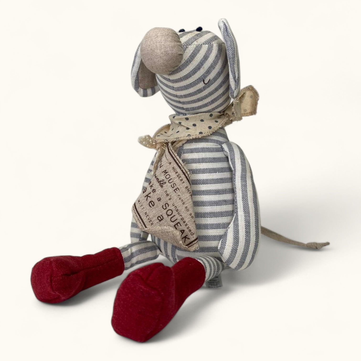 Striped toy mouse with a scarf on a white background