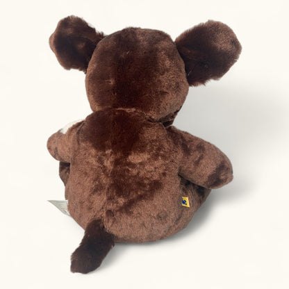Brown teddy bear with a visible brand label on a white background