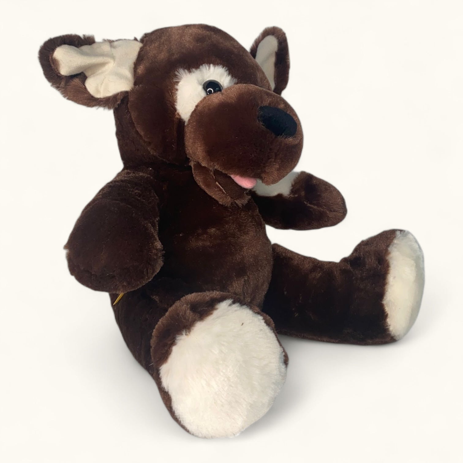 Brown plush dog toy with white paws on a white background