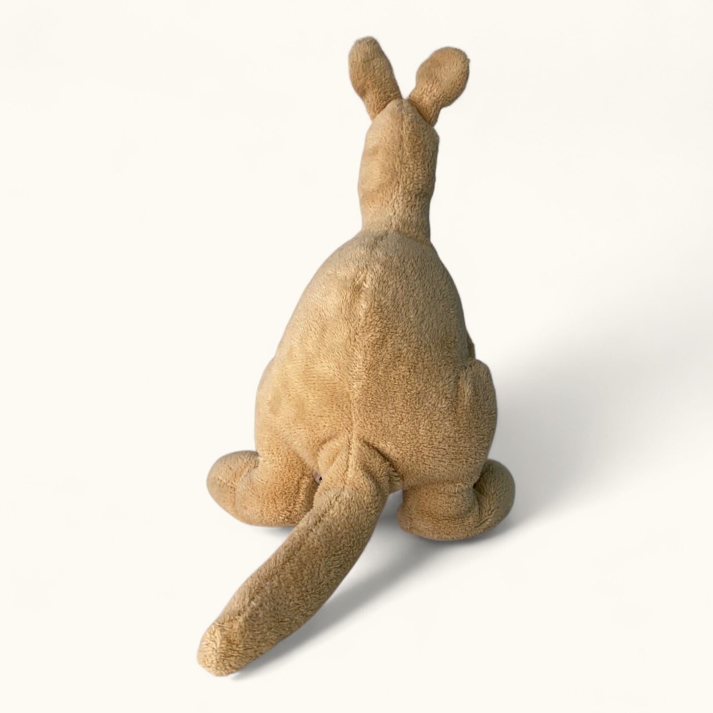 Brown plush kangaroo toy on a white background