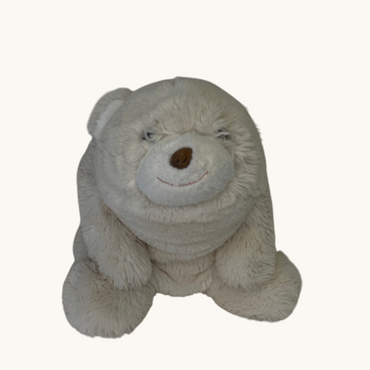 A plush white teddy bear toy with a brown stitched nose and eyes, sitting against a plain off-white background.