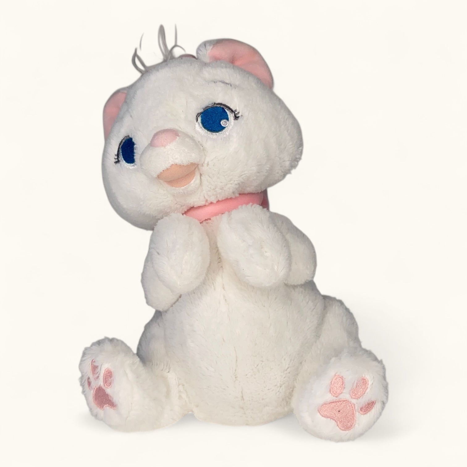 White plush cat toy with pink accents on a white background