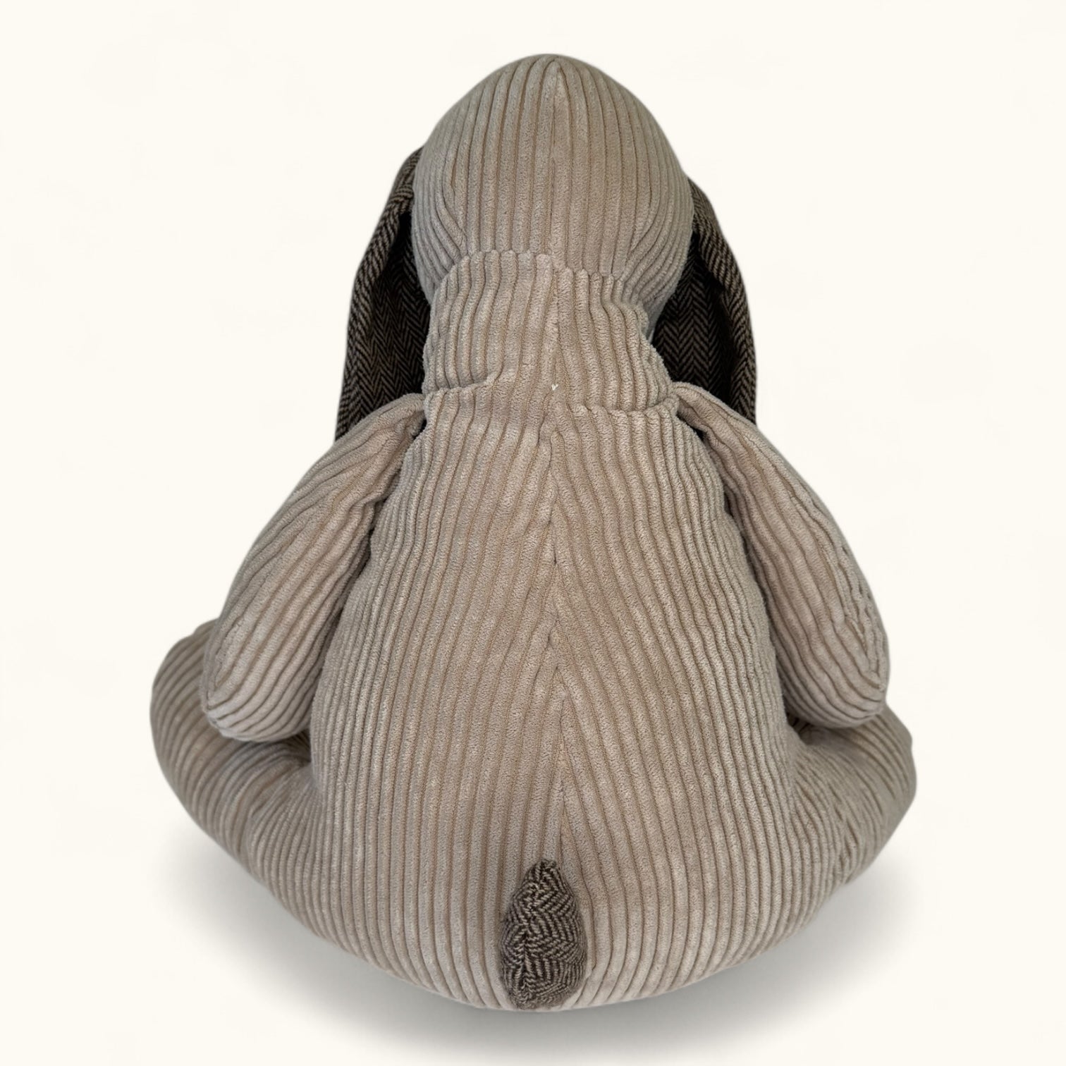 Beige dog toy on a white background