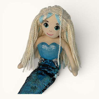 Mermaid doll with blue hair and a blue dress on a white background